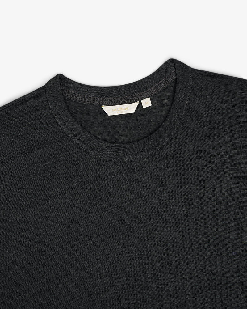 Linen Tee in dark gray, crew neck style, laid flat to display upper chest, collar, and inner neckline tag.