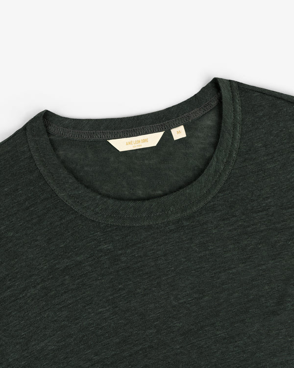 Close-up of a dark green Long-Sleeve Linen Tee, crew neck, with visible M size tag and brand details.
