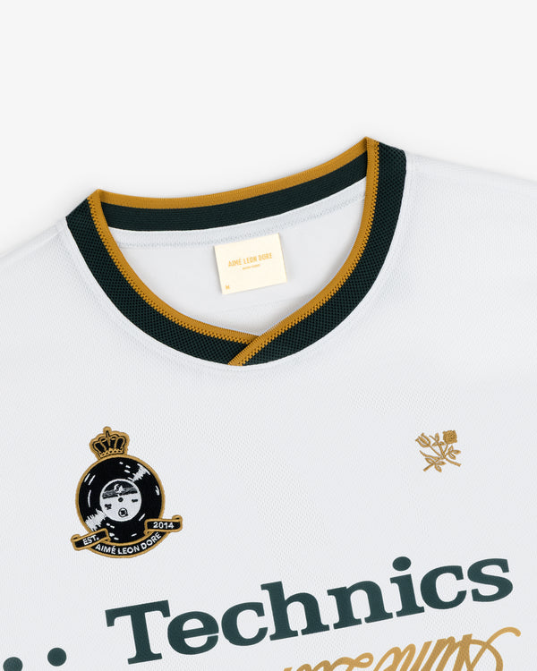 ALD / Technics Soccer Jersey: white with black and gold trim, Technics logo, crest, and Aimé Leon Dore collar label.
