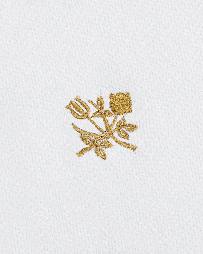 ALD / Technics Soccer Jersey featuring gold embroidered tulip and rose with leaves on white textured fabric.
