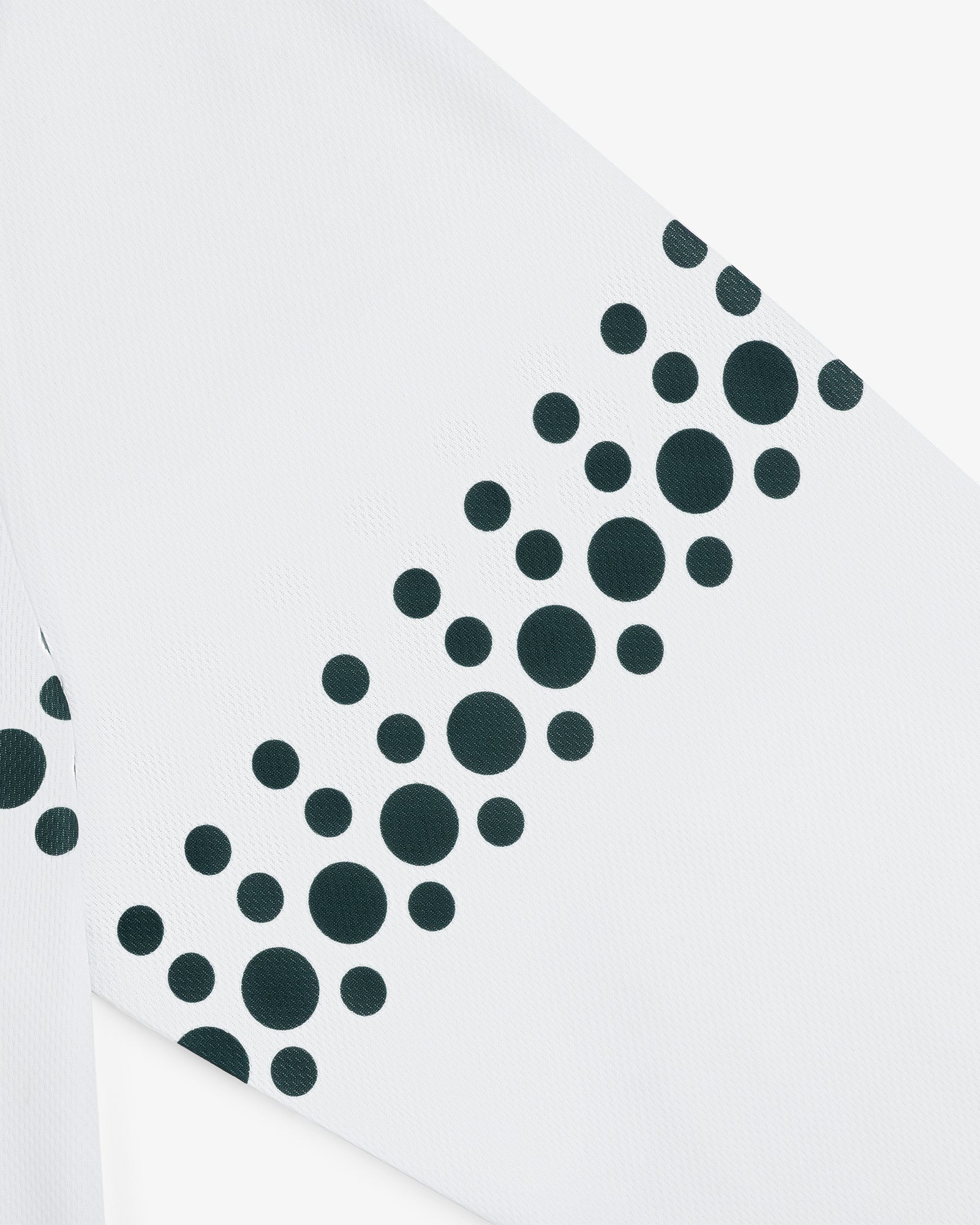 The ALD / Technics Soccer Jersey features white fabric with black dots of various sizes arranged diagonally.