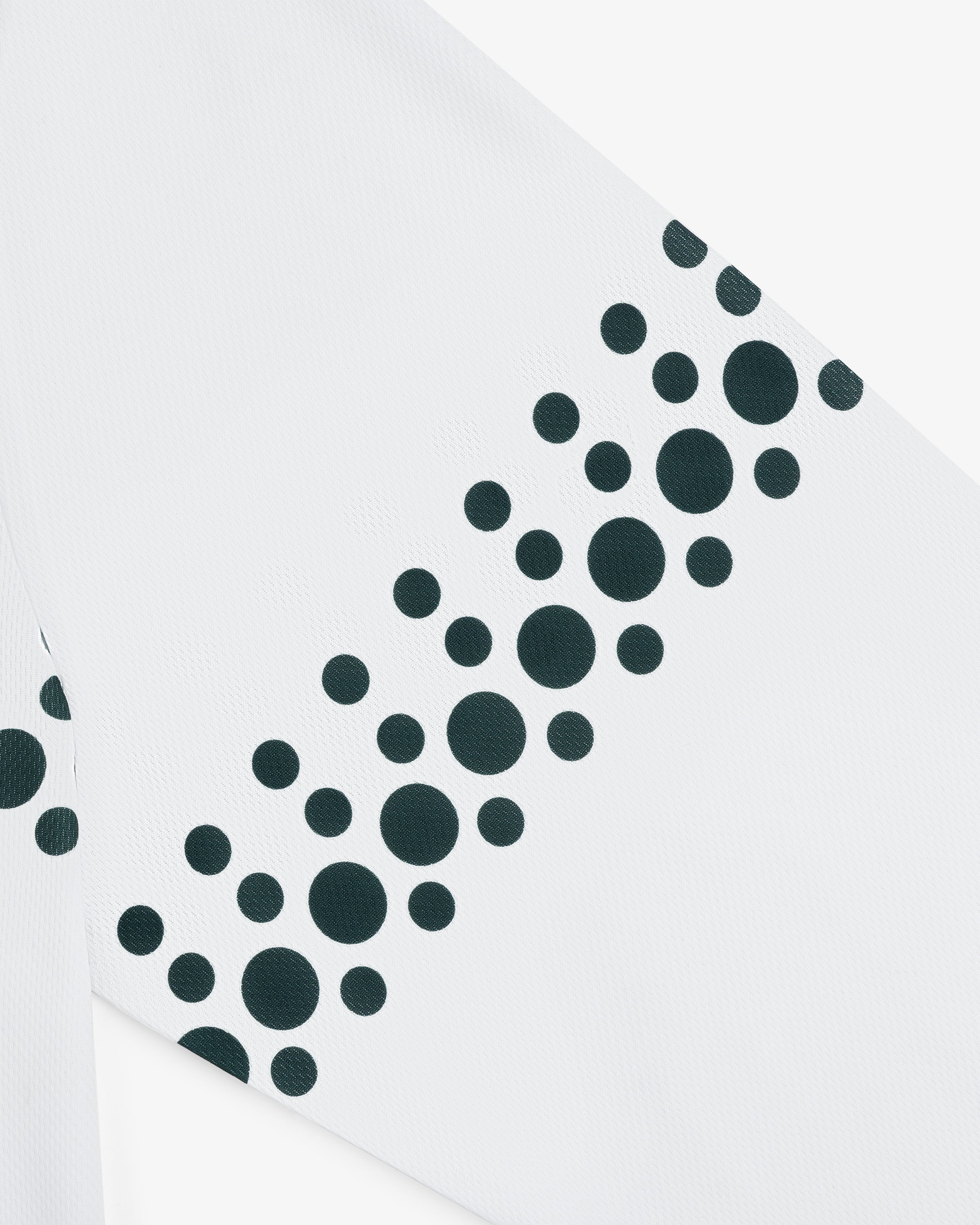 The ALD / Technics Soccer Jersey features white fabric with black dots of various sizes arranged diagonally.