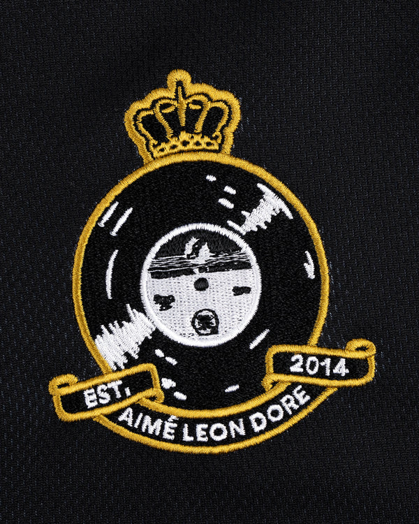 Black and gold Aimé Leon Dore patch with crown, vinyl, and EST 2014 on ALD / Technics Soccer Jersey.