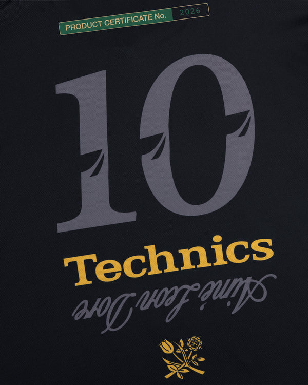 ALD / Technics Soccer Jersey: black with large gray 10, yellow Technics, cursive Since 1972 Love above a rose.