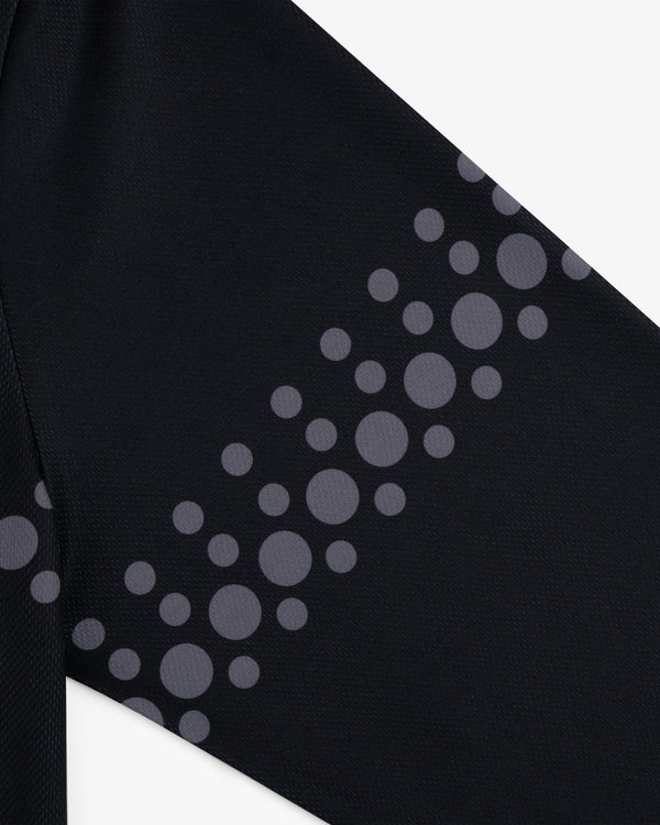 Close-up of black ALD / Technics Soccer Jersey with gray circles in various sizes arranged diagonally.
