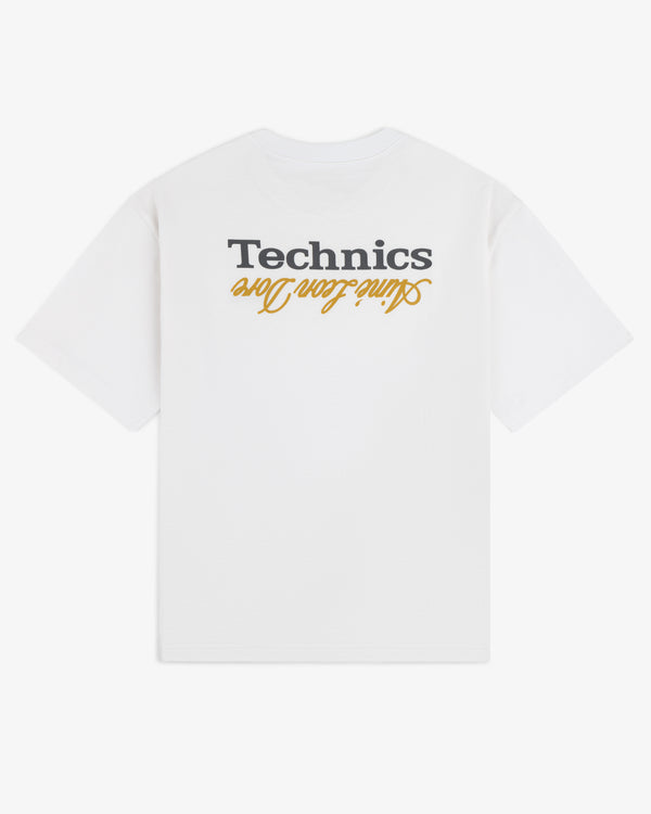 ALD / Technics Logo Tee with “Technics” and “saving lives” printed upside down in black and yellow on the back.