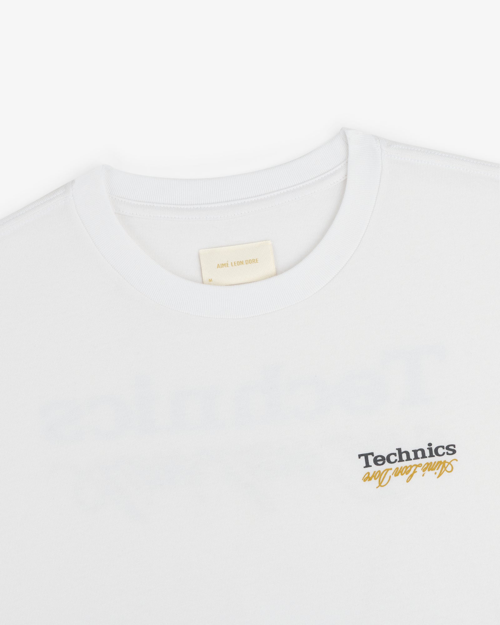 White ALD / Technics Logo Tee with "Such Fun" printed in black and yellow near the bottom right.
