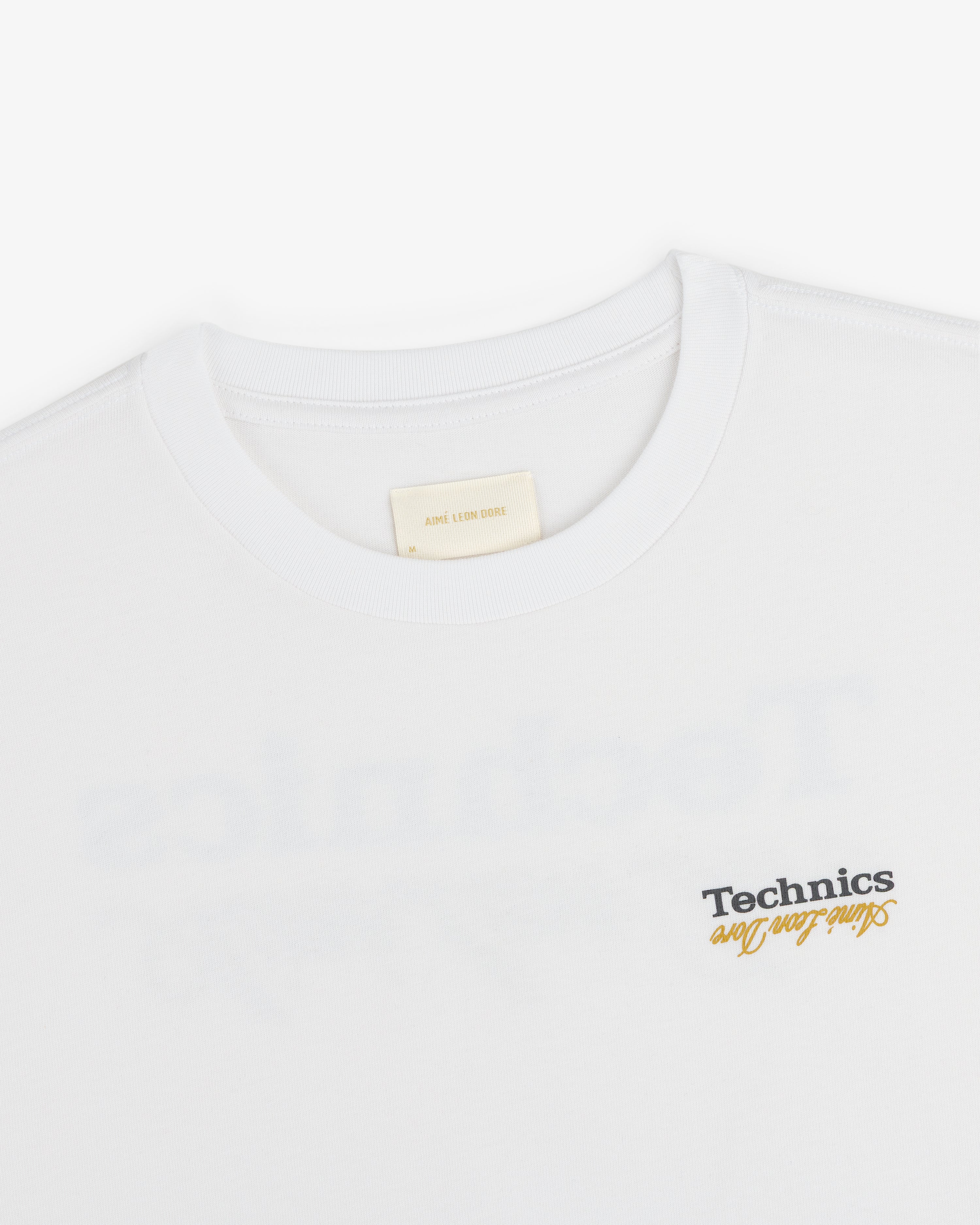 White ALD / Technics Logo Tee with "Such Fun" printed in black and yellow near the bottom right.