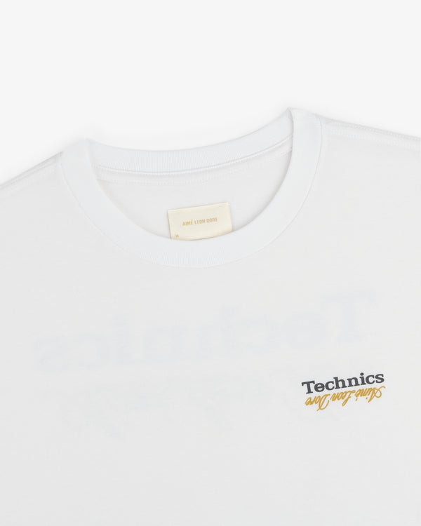 White ALD / Technics Logo Tee with "Such Fun" printed in black and yellow near the bottom right.