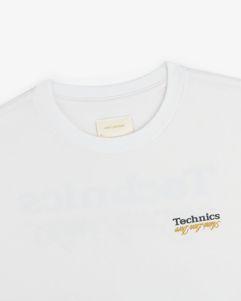 White ALD / Technics Logo Tee with "Such Fun" printed in black and yellow near the bottom right.