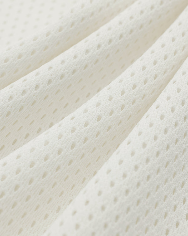 Close-up of the Mesh Batting Practice Jersey's white, breathable mesh fabric with small, evenly spaced holes.