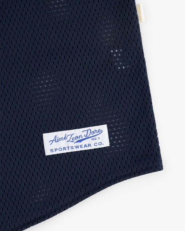 Close-up of navy blue Mesh Batting Practice Jersey with a white Aimé Leon Dore Sportswear Co. label sewn on.