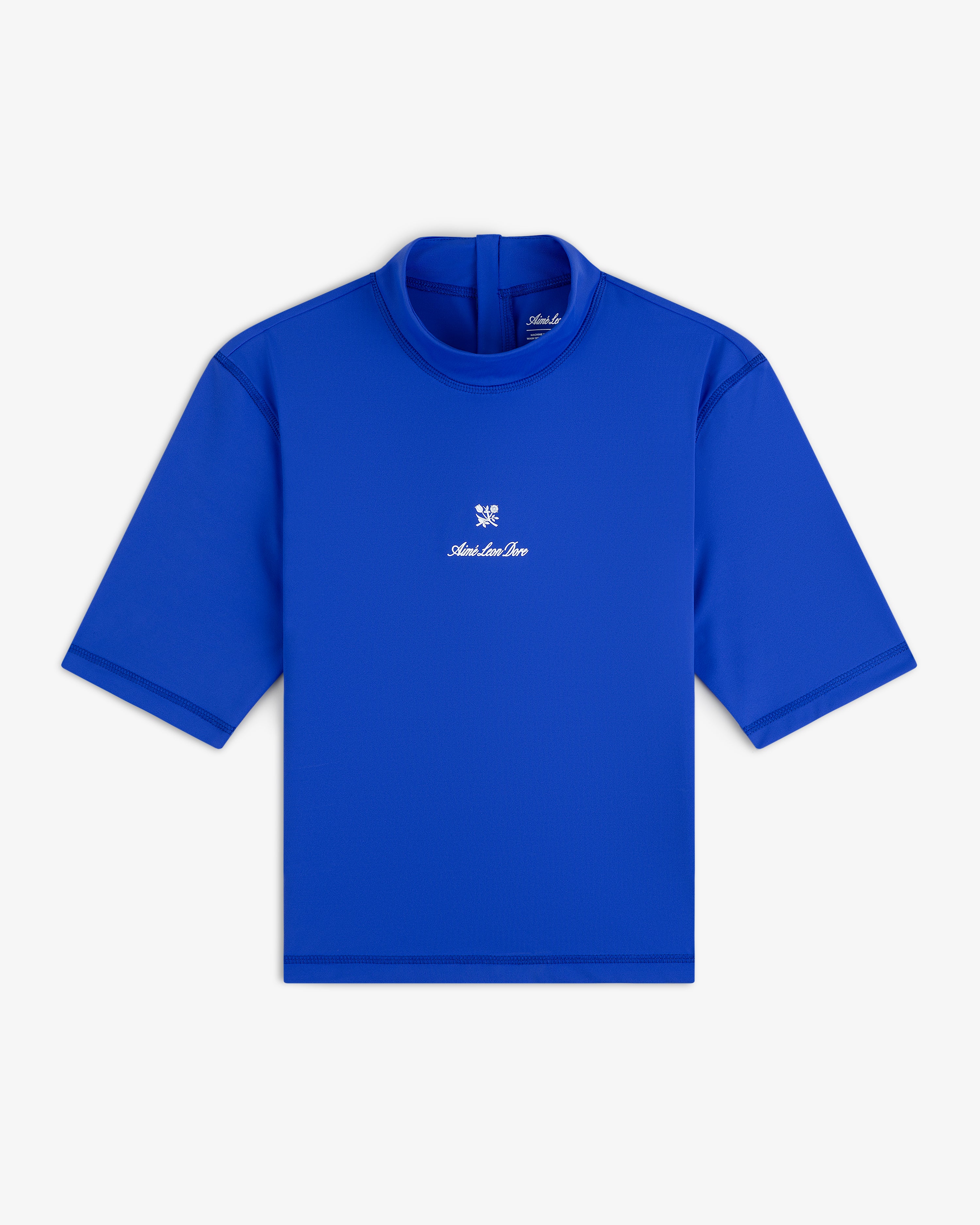 Short Sleeve Crest Rash Guard in bright blue with high collar and small white logo and emblem on the chest, laid flat.