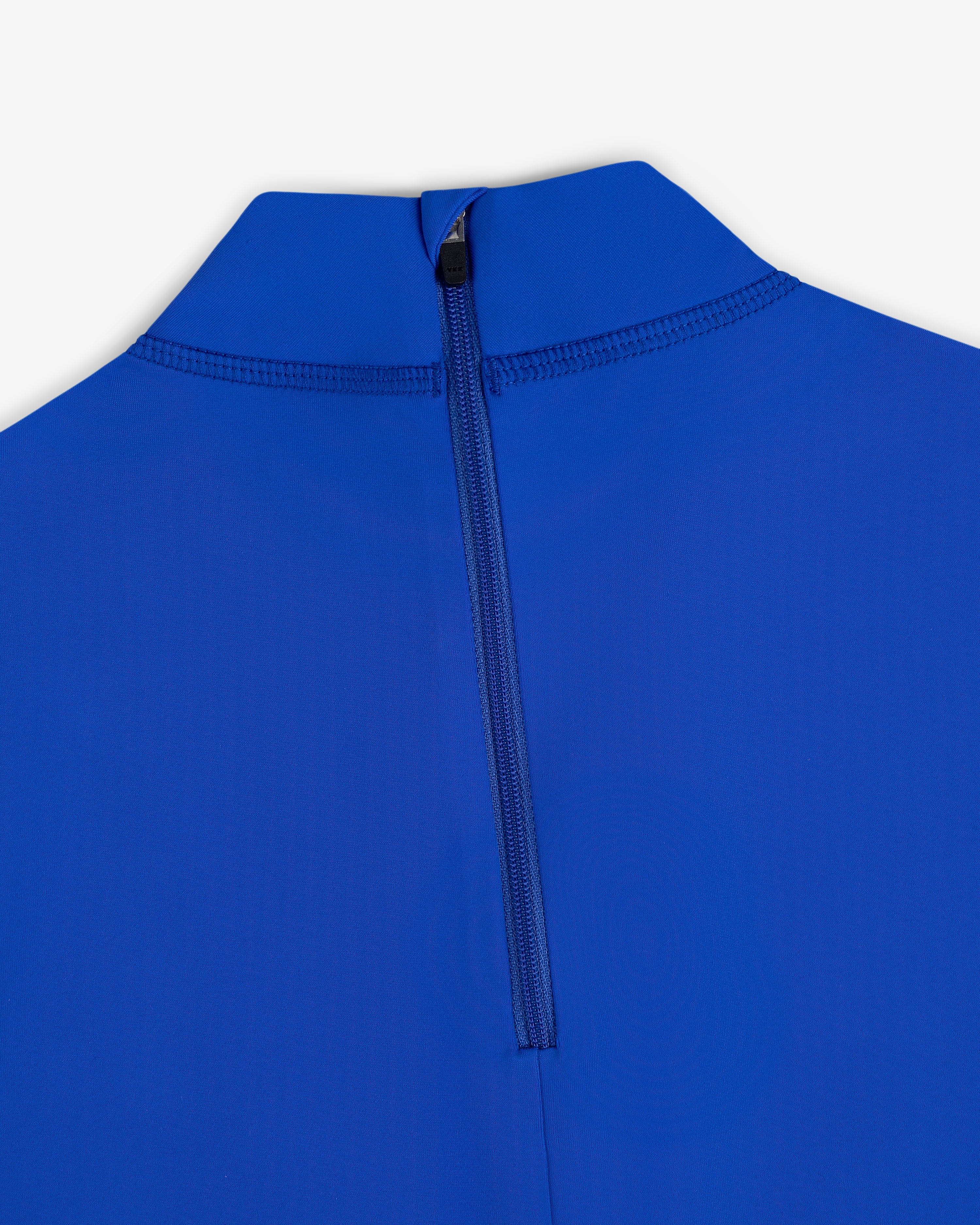 Close-up of the Short Sleeve Crest Rash Guard in blue with a black back zipper and high collar against a white background.