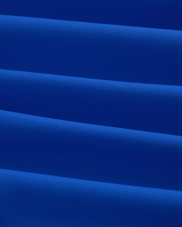 Close-up of evenly folded Short Sleeve Crest Rash Guard, forming horizontal ridges and shadows.