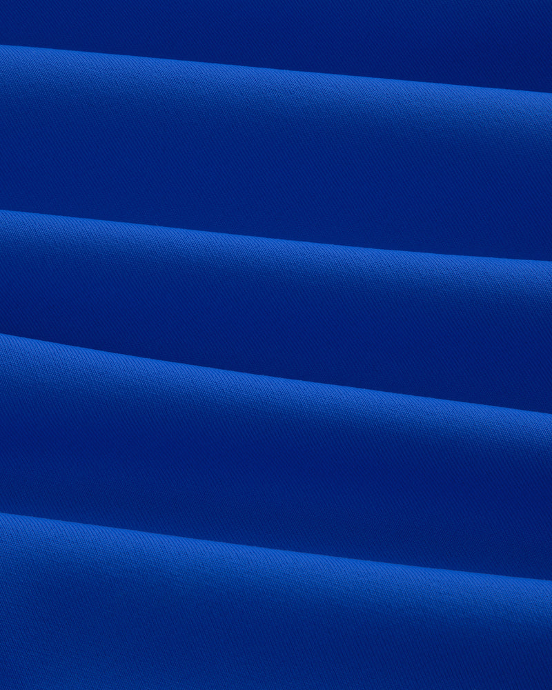Close-up of evenly folded Short Sleeve Crest Rash Guard, forming horizontal ridges and shadows.