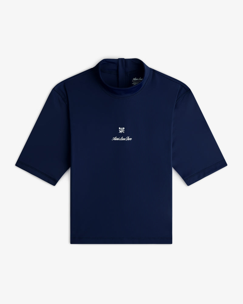 Short Sleeve Crest Rash Guard in navy, high collar, small white logo and text on chest, laid flat on white background.