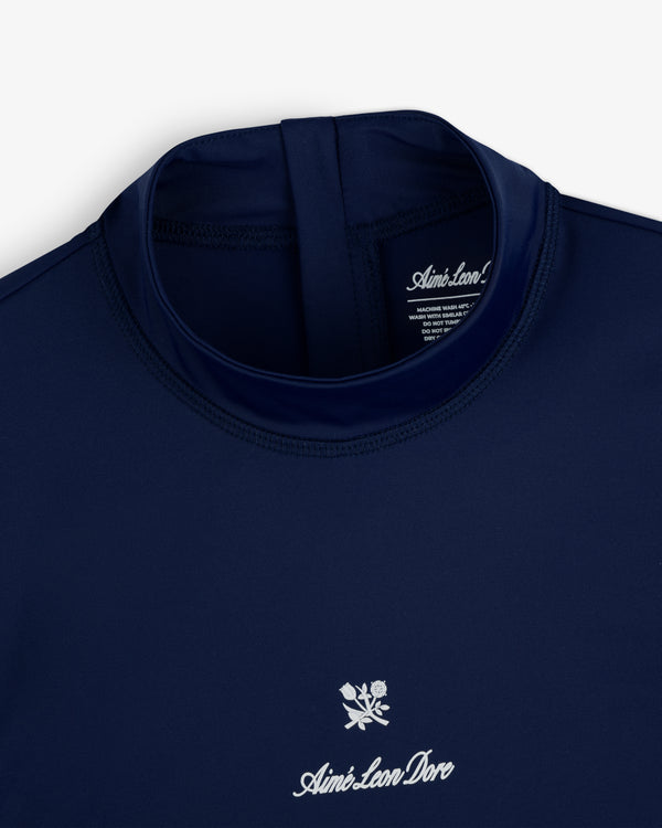 Navy blue Short Sleeve Crest Rash Guard by Aimé Leon Dore with a white logo and rose graphic below the collar.