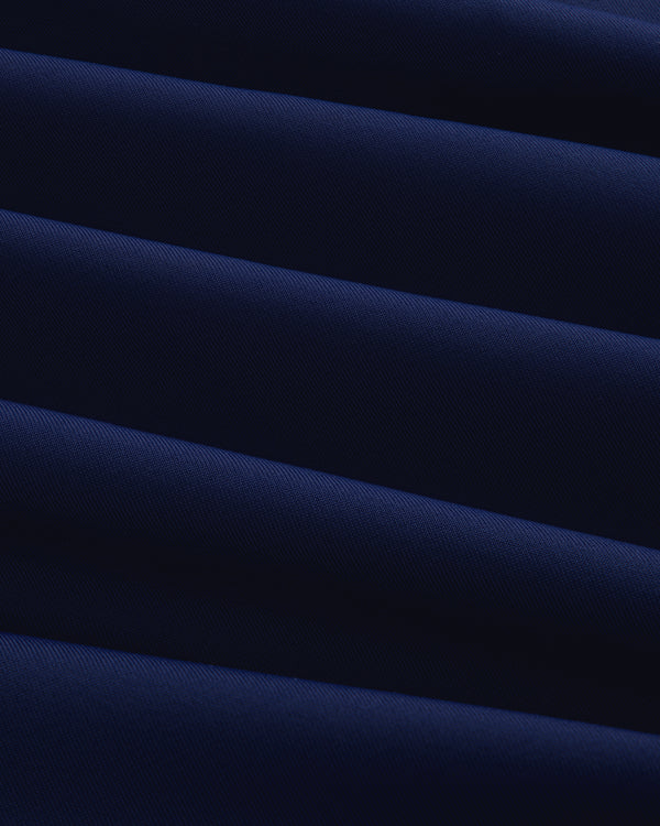 Close-up of Short Sleeve Crest Rash Guard in dark blue with diagonal folds creating light and shadow patterns.