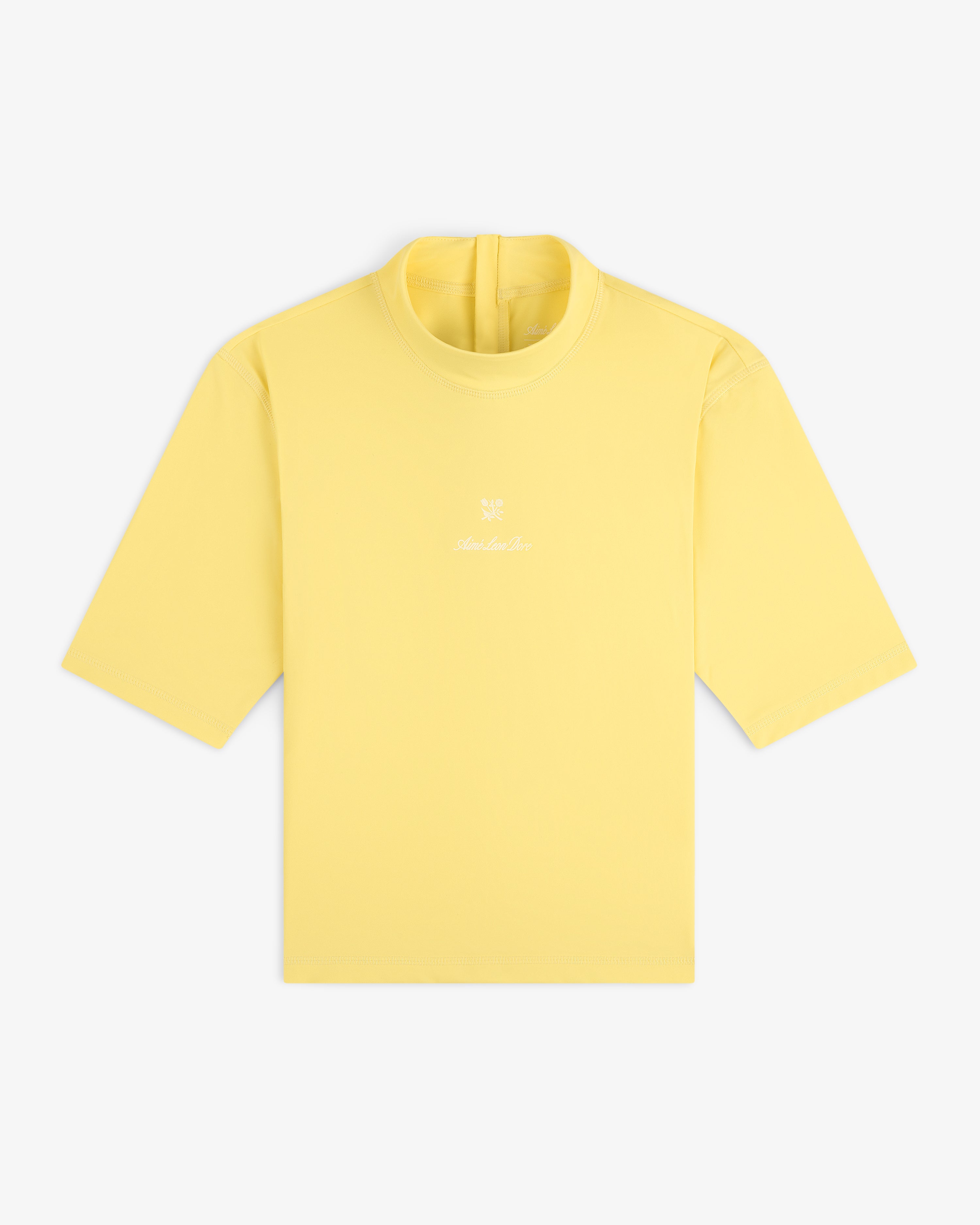 Short Sleeve Crest Rash Guard in light yellow with small white logo and text on chest, shown on white background.