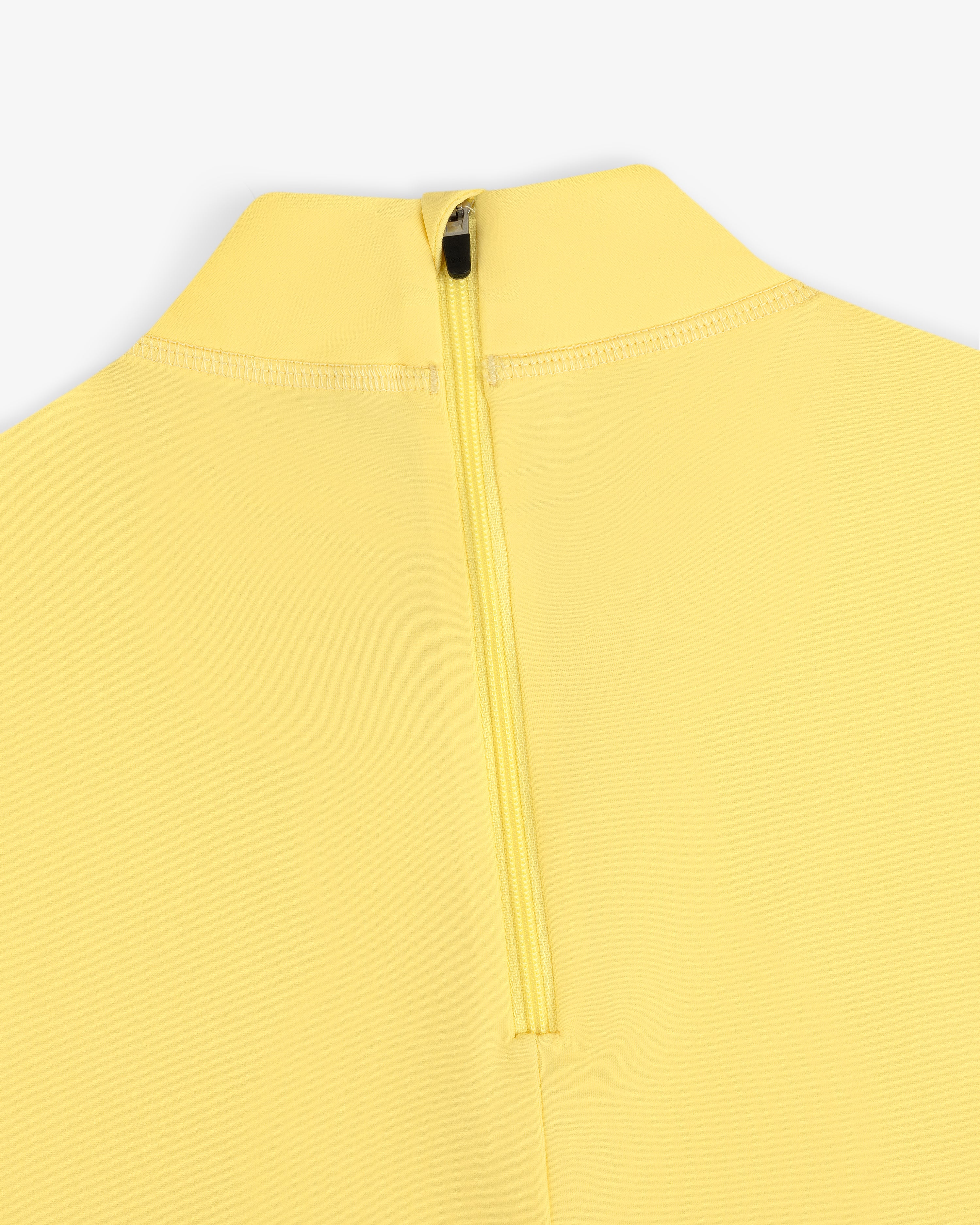 Close-up of the Short Sleeve Crest Rash Guard in yellow with a visible zipper at the back near the collar.