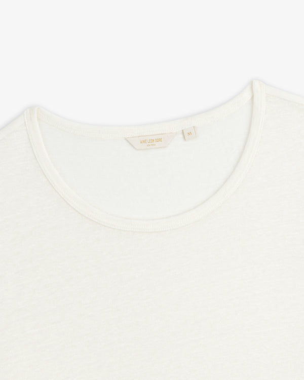 Close-up of the neckline of a plain white Linen Tee crew neck on a white background.