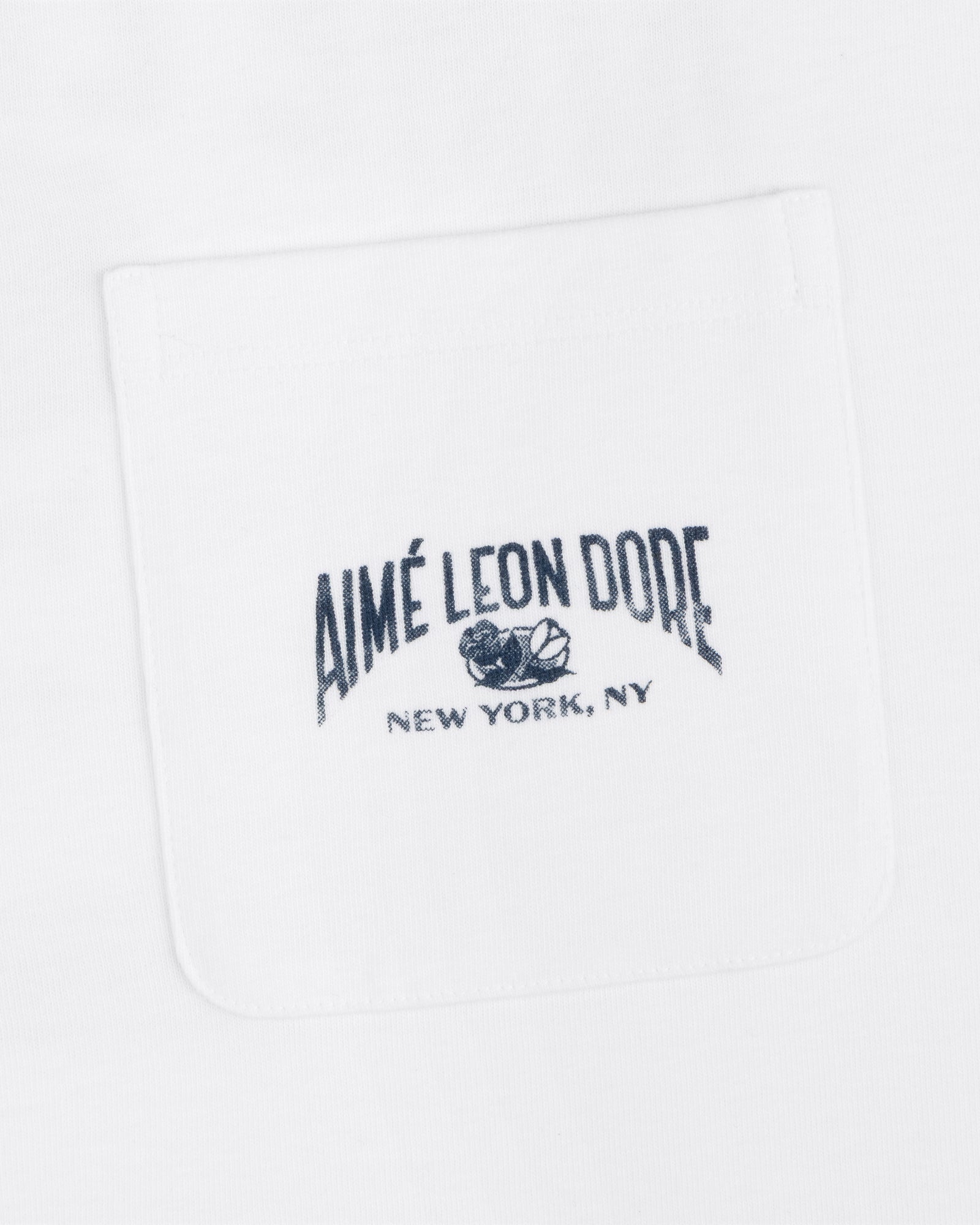 Neighborhood Pocket Tee in white with black "Aimé Leon Dore New York, NY" and rose embroidery on the front pocket.