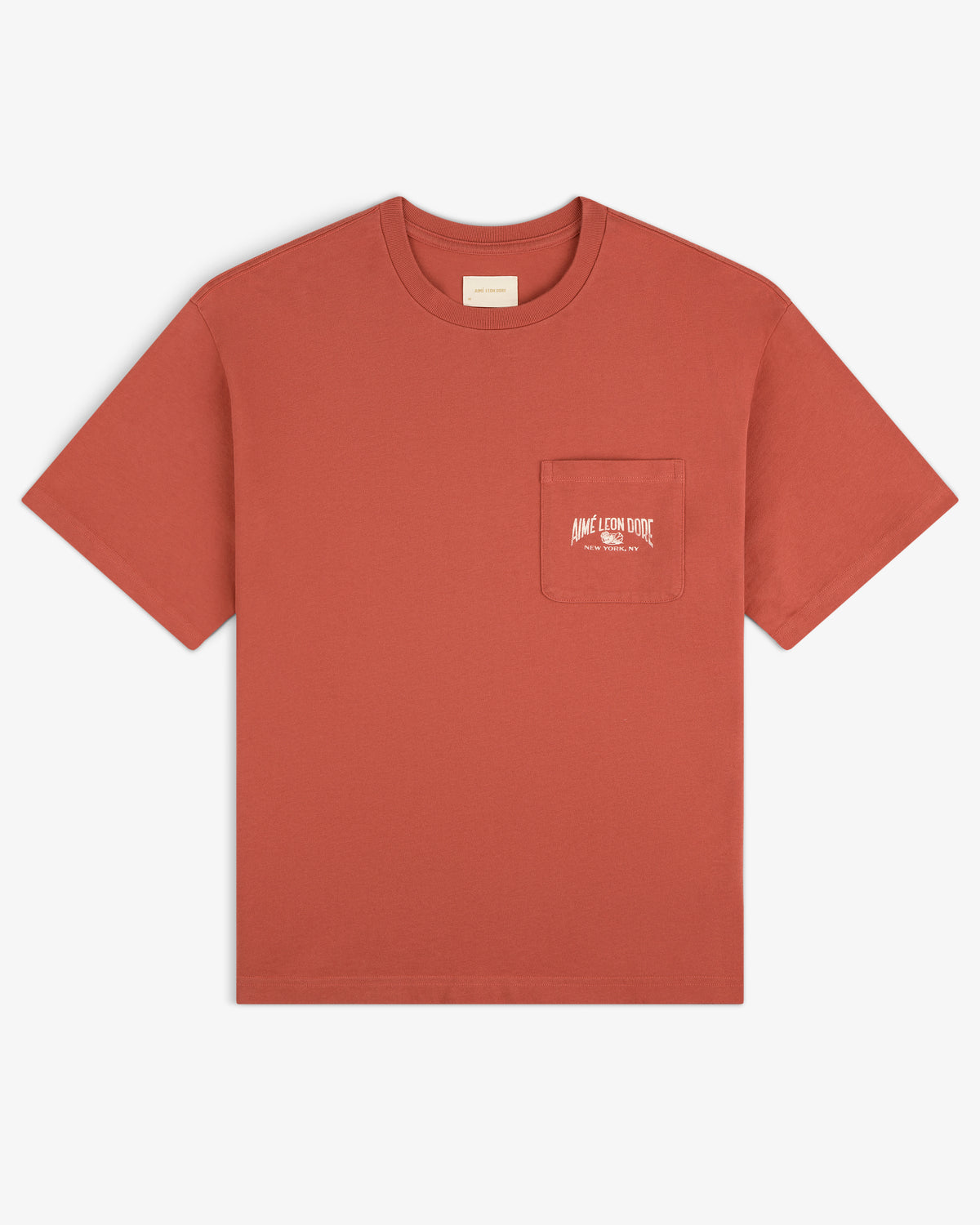 Neighborhood Pocket Tee in rust red, features a chest pocket with small white text printed on the pocket.
