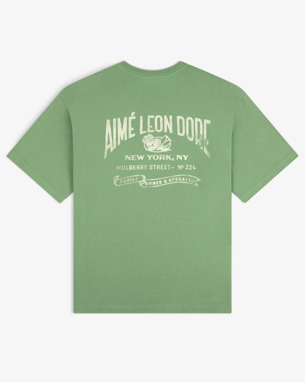 Neighborhood Pocket Tee featuring “Aimé Leon Dore New York, NY Mulberry Street” graphic text in white on the back.