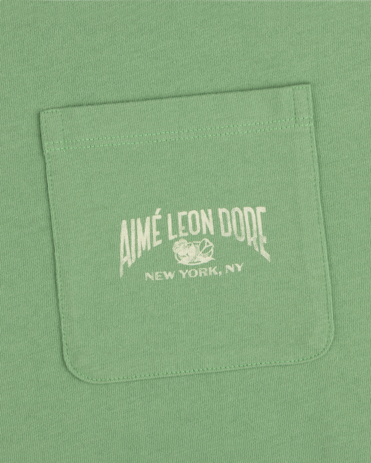 Neighborhood Pocket Tee in green with AIMÉ LEON DORE NEW YORK, NY and sports graphics printed in white on the pocket.