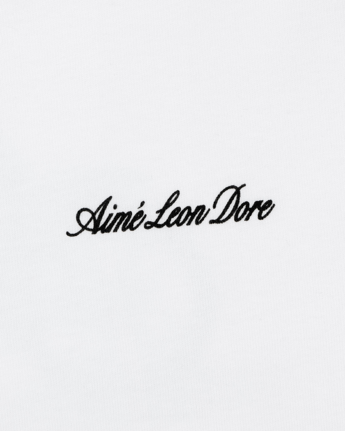 Black script "Aimé Leon Dore" embroidered on a plain white Super Cub Tee.