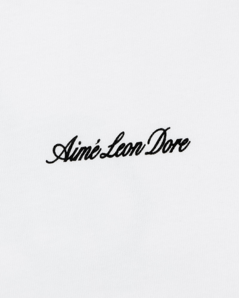 Black script "Aimé Leon Dore" embroidered on a plain white Super Cub Tee.