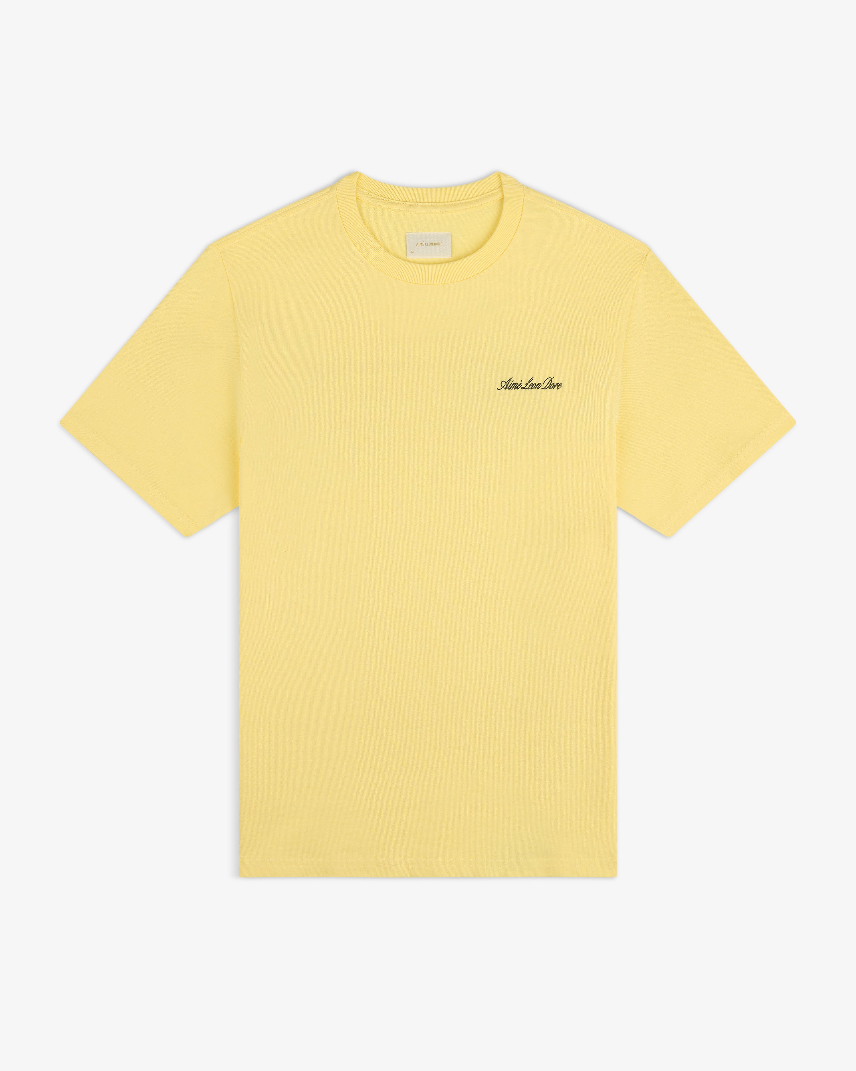 Super Cub Tee: yellow short-sleeve with small black cursive text on left chest, shown on white background.