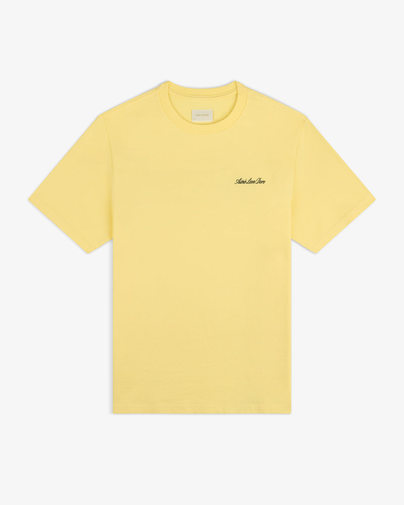 Super Cub Tee: yellow short-sleeve with small black cursive text on left chest, shown on white background.