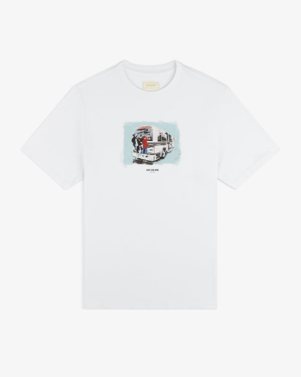 Mesaikos Commuter Tee: white T-shirt with a small illustrated graphic of a truck and people on the chest.