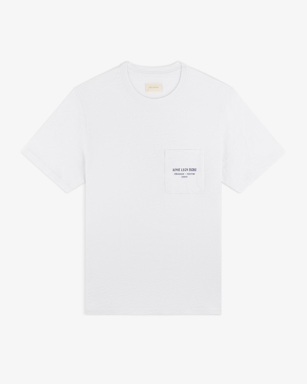 Artiste Pocket Tee: White short-sleeve T-shirt with a chest pocket and small printed text on the pocket.