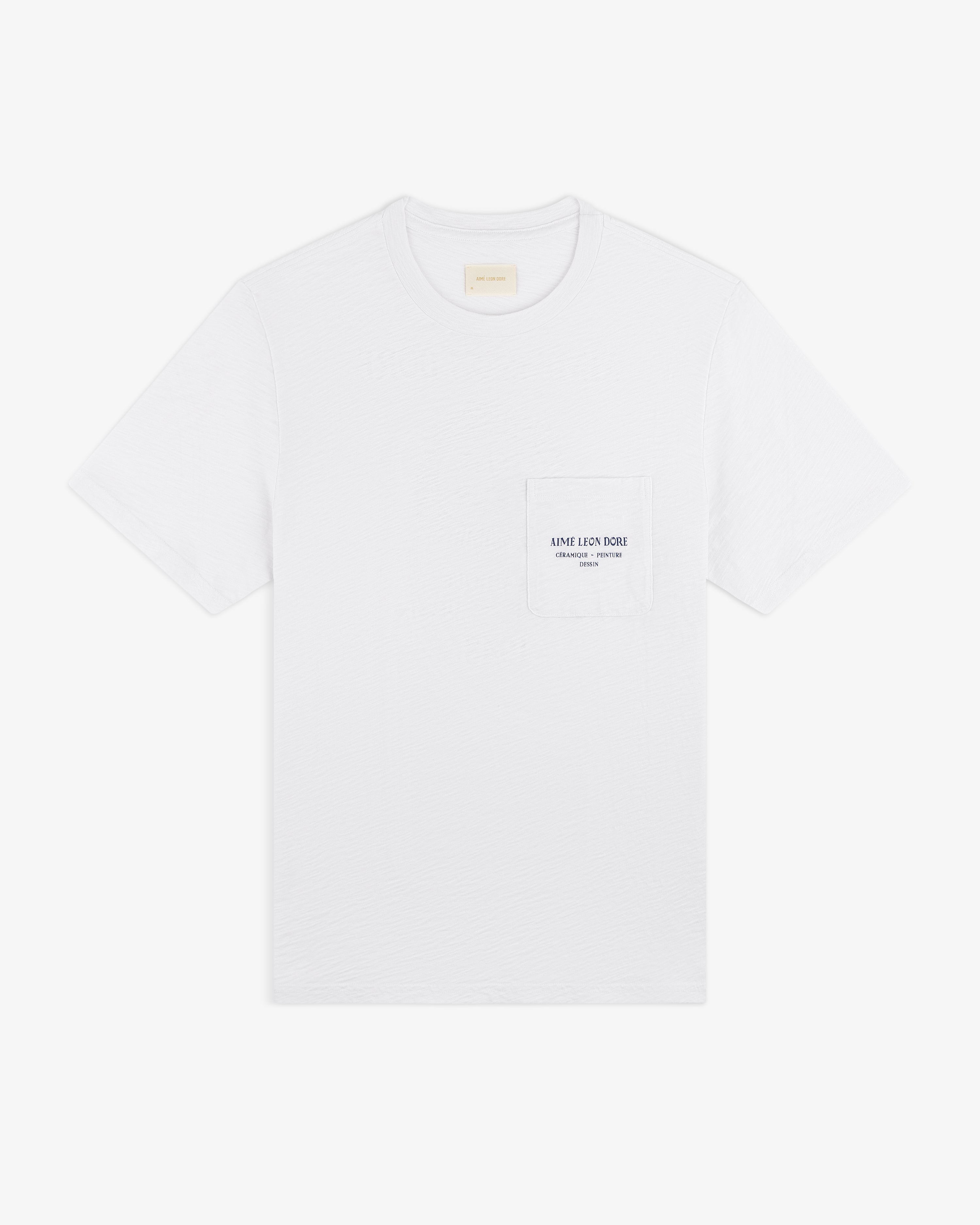 Artiste Pocket Tee: White short-sleeve T-shirt with a chest pocket and small printed text on the pocket.