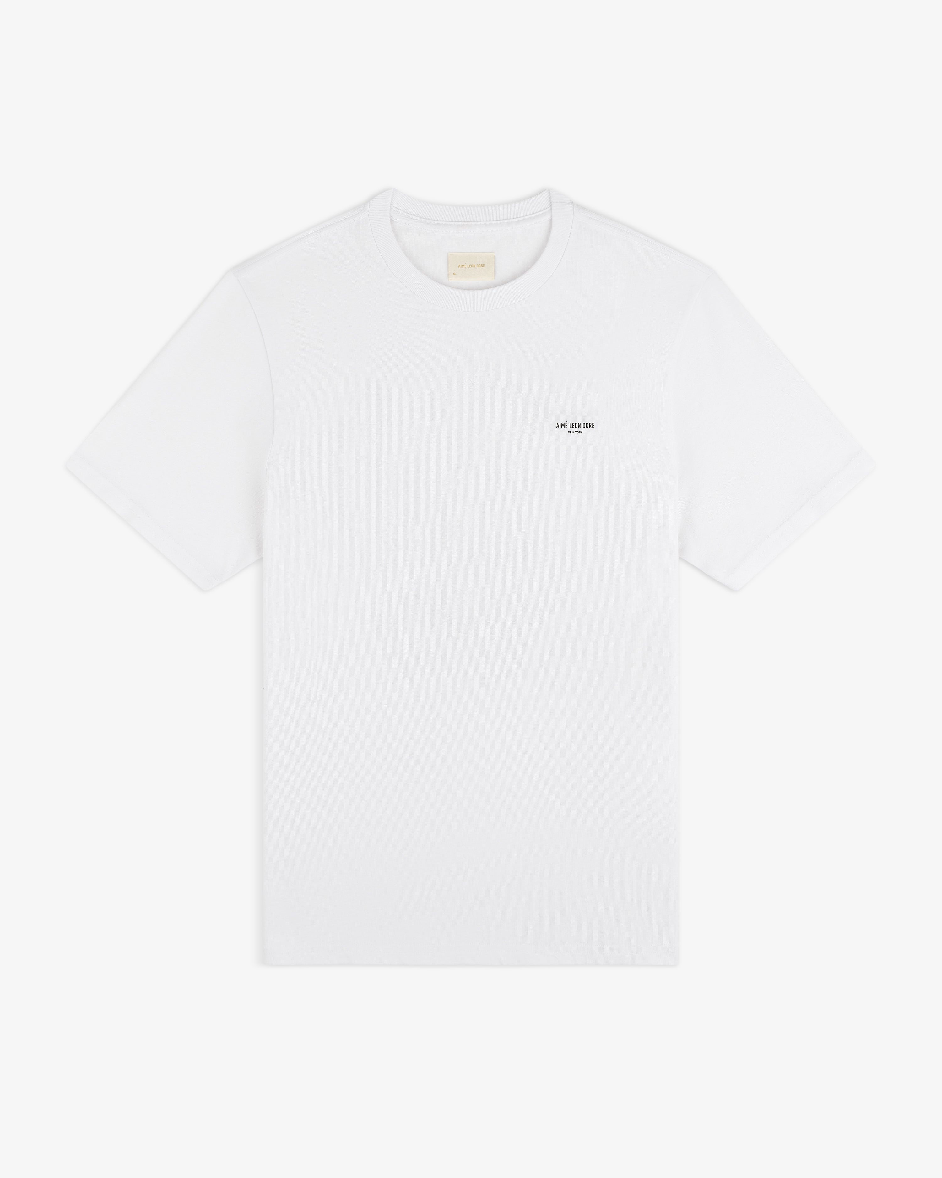 Mott Street Tee: plain white short-sleeve shirt with a subtle black text detail on the left chest.
