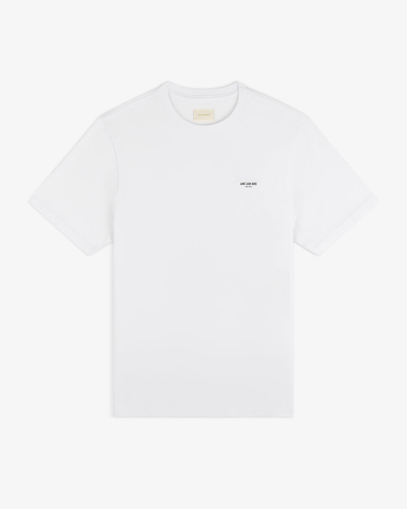 Mott Street Tee: plain white short-sleeve shirt with a subtle black text detail on the left chest.