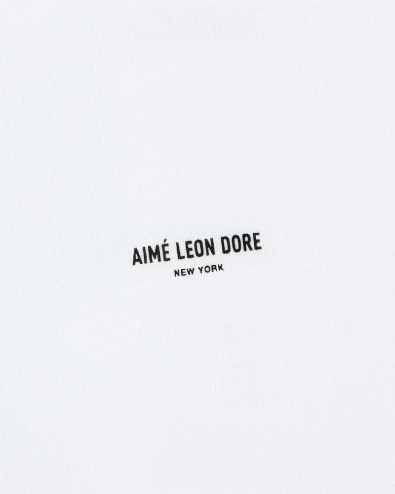 White Mott Street Tee with "AIMÉ LEON DORE NEW YORK" in small black uppercase letters at the center.