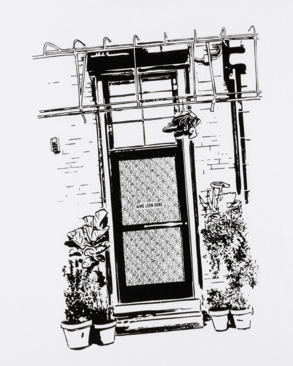 Black and white illustration of a door with "Mott Street Tee," potted plants by the entrance, and a metal awning above.