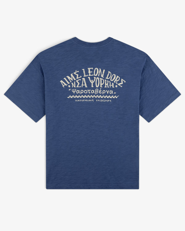Taverna Tee: Blue short-sleeve shirt with white Greek/English text and wave designs on the back.