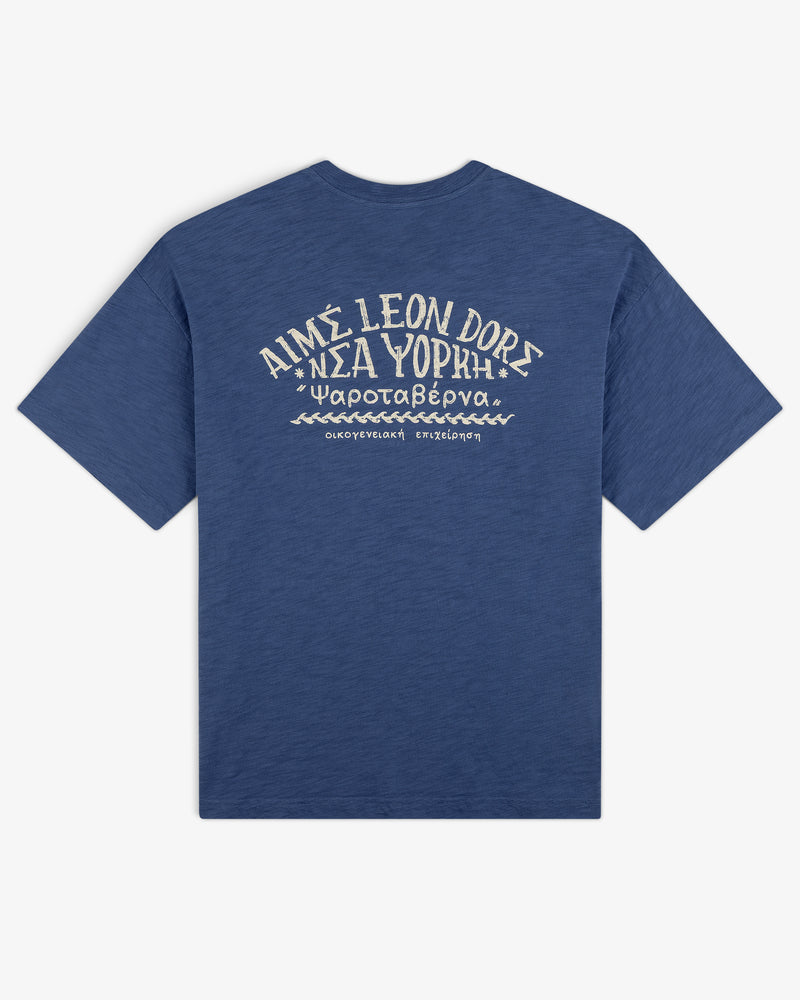 Taverna Tee: Blue short-sleeve shirt with white Greek/English text and wave designs on the back.