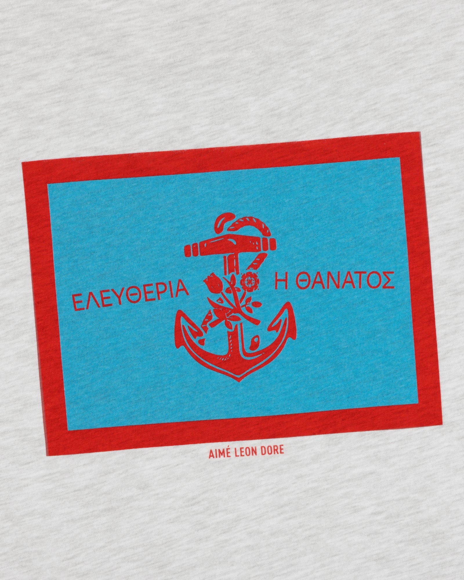 AIMÉ LEON DORE Coastal Flag Tee: Blue rectangle, red anchor & Greek text on light gray with red border.