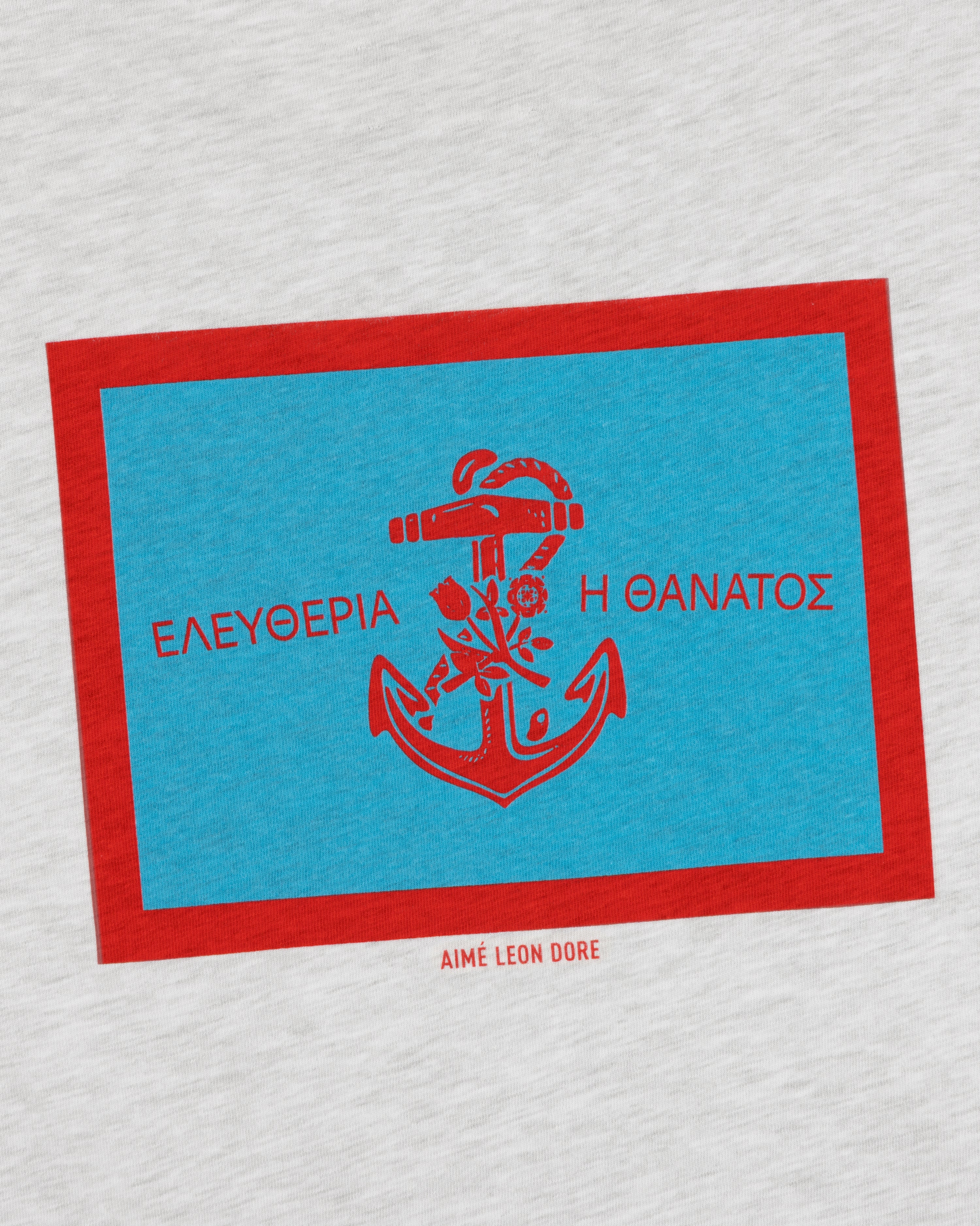 AIMÉ LEON DORE Coastal Flag Tee: Blue rectangle, red anchor & Greek text on light gray with red border.