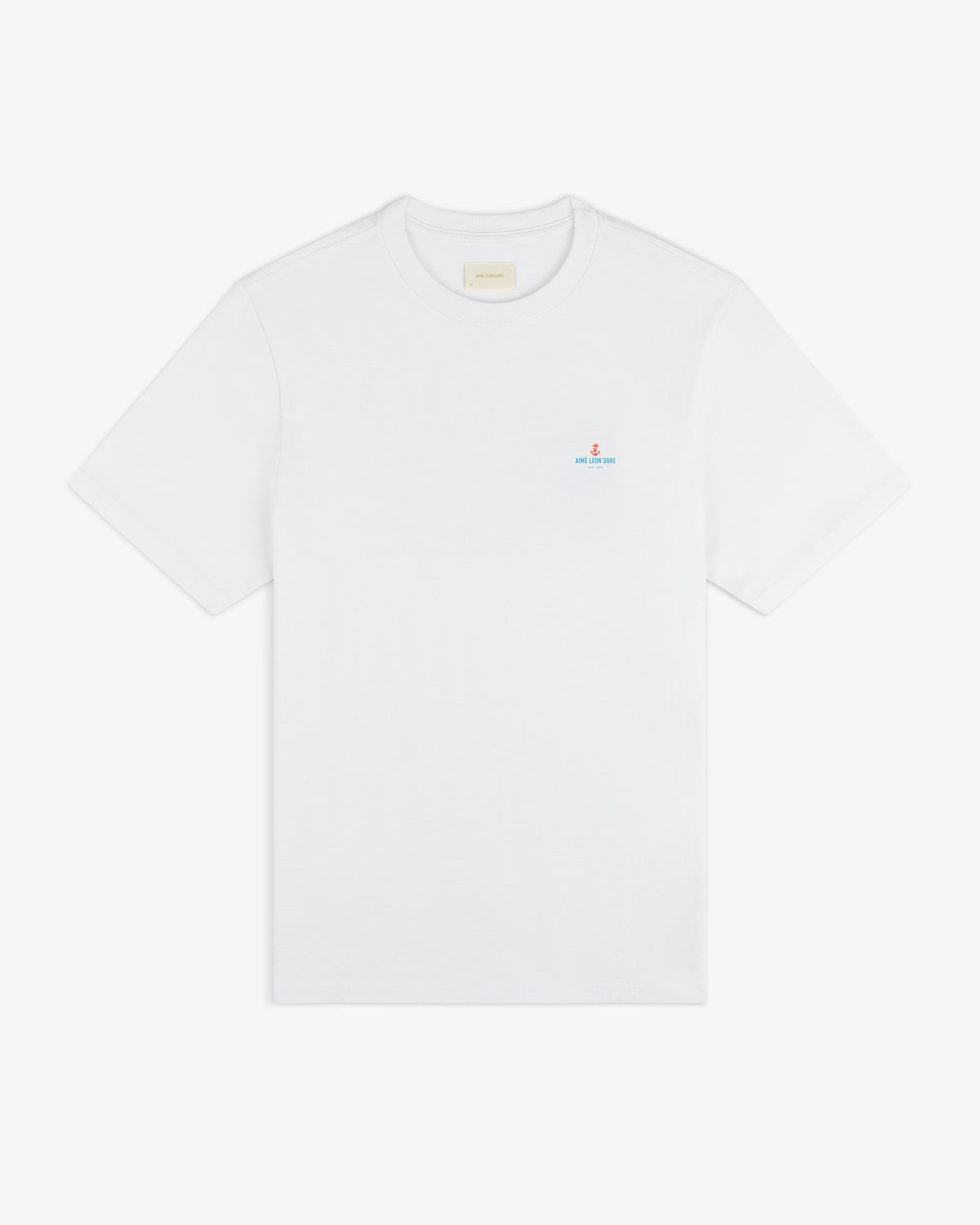 Coastal Flag Tee: white short-sleeve shirt with a small blue and red logo on the left chest.