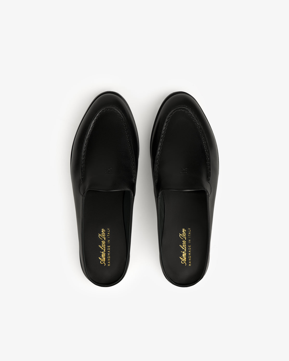 The Venetian Mule in black leather, slip-on loafers shown from above on a white background.