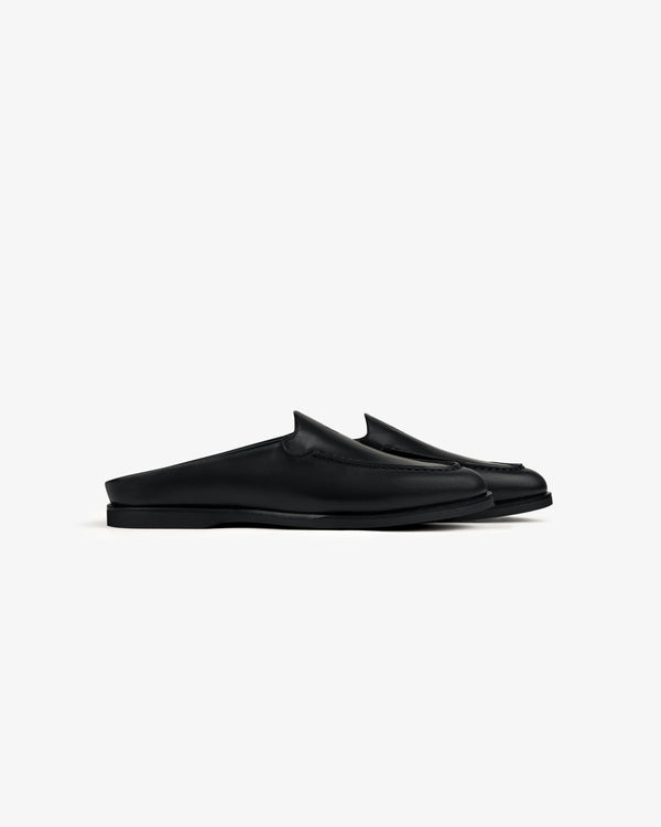 Venetian Mule: black leather slip-on loafers with closed toe and open heel, shown side view on white background.
