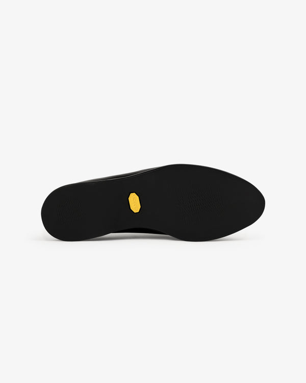 Venetian Mule shoe sole with a small yellow hexagonal logo in the center, shown on a white background.