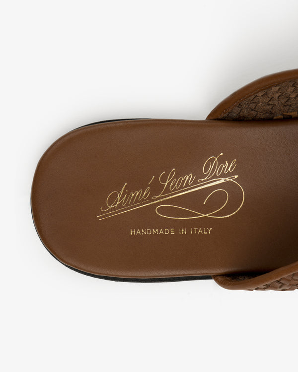 Close-up of a Leather Raffia Mule with Aimé Leon Dore Handmade in Italy written in gold script on the insole.